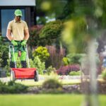 Landscaper Spreading Fertilizer on Lawn